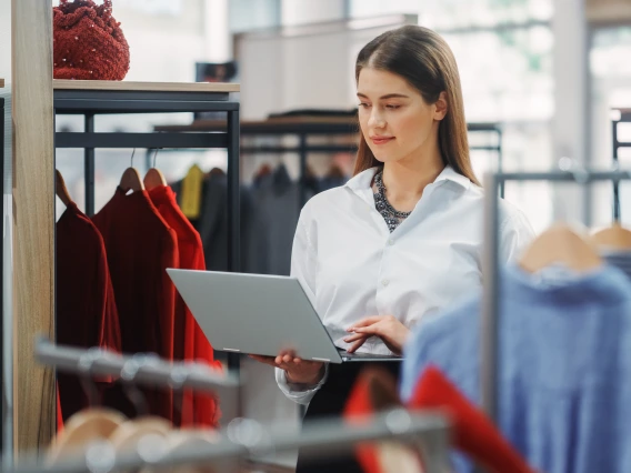 college student with laptop browsing professional attire